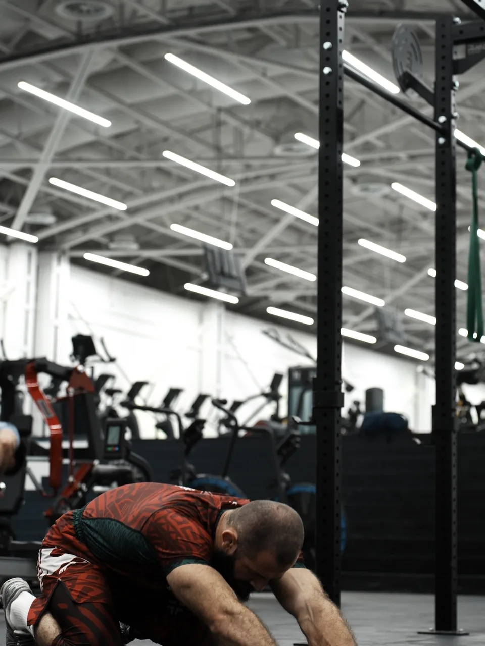 Muhammad Magomedov demonstrating a controlled deep-leg mobility position in the Cumados gym